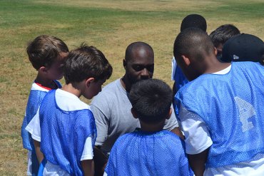 George Gaffney, Ausberry's brother, gives a group of camp participants tips on football.